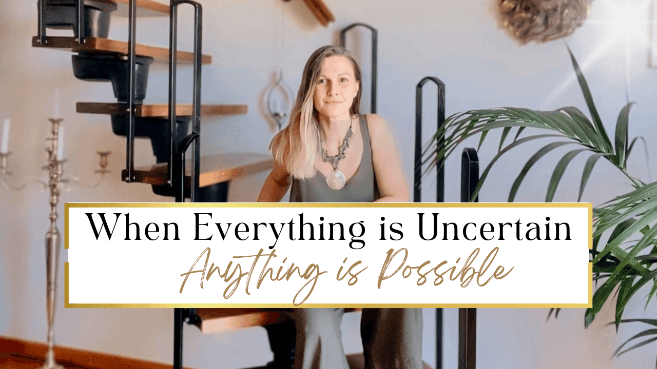Allegra sitting on one of the lower steps of a small wooden staircase in her home, a large standing silver candlestick to her left, a large beautiful plant on her right with the sun shining through and the words in black and gold "When everything is uncertain - Anything is possible."  